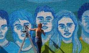 Student participating in Writings on the Wall